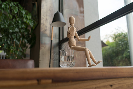 人坐在水的杯上玩具娃娃模型木偶杯子绘画玻璃姿势人体咖啡图片
