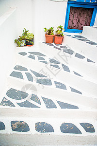 希腊老村街道上台阶上鲜花的传统希腊彩色花盆花瓶房子文化旅行街道建筑村庄植物石头旅游图片