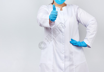 穿着白大衣和面罩 穿蓝色医用乳胶g卫生成人诊所药品职业拇指手势女性保健专家图片