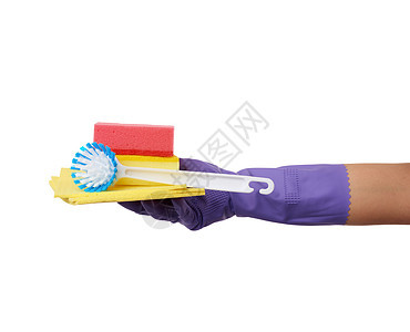 一个用来清洁的紫色橡胶手套 在手上穿衣服 堆叠图片