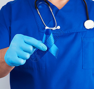 穿蓝制服的医生和不消毒的乳胶手套有黑发炎癌症诊所药剂师机构生存蓝色医院药物活动男人图片