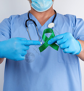 蓝制服医生和乳胶手套的绿丝带为预防专家麻痹治疗丝带帮助诊所药品机构曲线图片