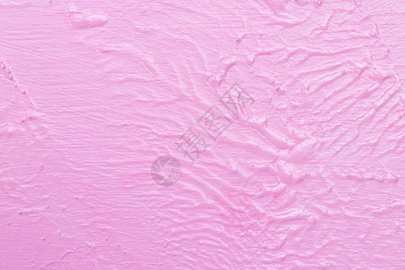粗糙的粉红色墙壁的质地和不均匀的水彩画图片