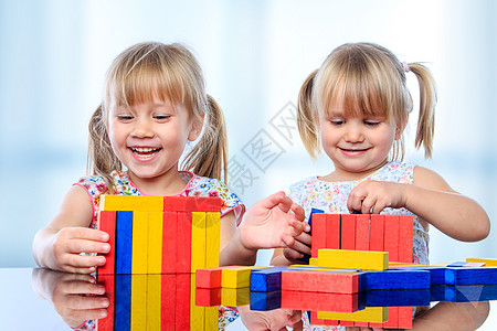 两个孩子在桌子上用木块建筑图片