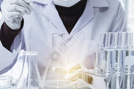 带有含液体的玻璃实验室化学测试管的研究员器皿蓝色烧瓶烧杯学习生物药品测试化学品工人图片