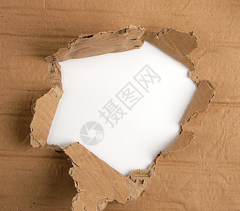 一张棕色的纸 上面有一个洞旋转圆圈框架白色床单裂缝边缘休息纸板边界图片