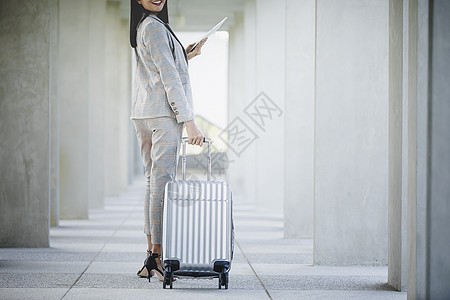 商业女商务人士的肖像 看着数字平板电脑和白色三角形技术女性旅游商务时间表乘客运输屏幕团体游客图片