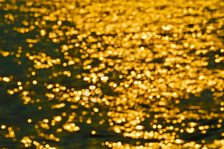 海水表面模糊彩光的金色抽象旅行反射阳光海浪钓鱼派对日落射线海洋街道图片