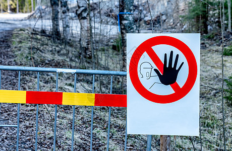 警告标志的特写照片-禁止进入禁区 标志挂在金属栅栏上 背景是森林 施工现场人身安全禁区 禁区 大风险区图片
