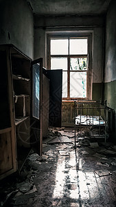 在切尔诺贝利一座废弃房屋中用窗户和床铺的房间图片