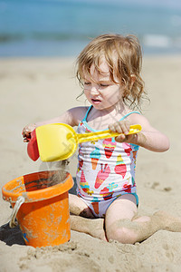 玩沙滩玩具的可爱小女孩高清图片