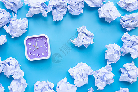 蓝色背景上带有白色皱巴巴纸球的方形时钟床单咖啡思维文档灯泡垃圾办公室商业技术人群图片