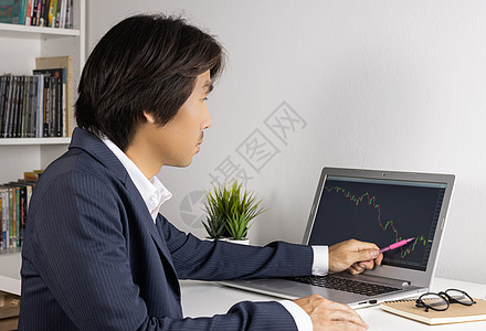 贸易商或投资者交易和指向Forex或Sto贸易职场笔记本投资市场股票顾问商务货币烛台图片