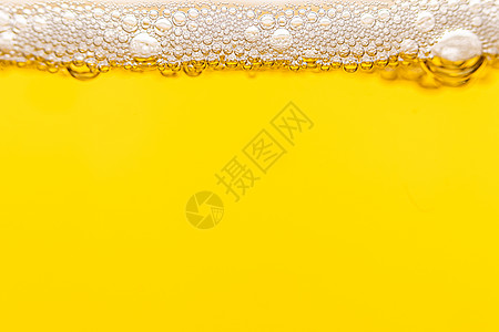 淡啤酒中气泡的质地饮料反射玻璃墙纸泡沫酒吧艺术橙子金子气体图片