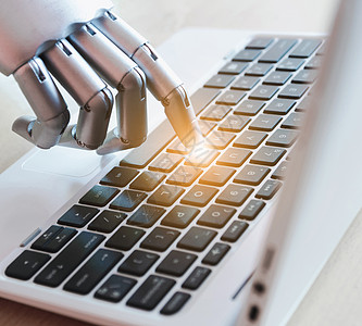 机器人的手和手指指向具有光效的笔记本电脑按钮顾问聊天机器人人工智能概念手臂自动化监控工厂商业软件深度技术互联网学习图片