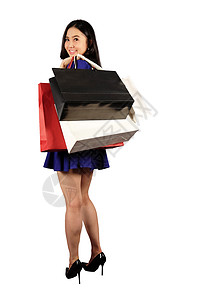 穿着蓝礼服的快乐女人 带着白后春梦的购物袋购物狂购物者顾客中心飞行商业头发消费者裙子人群图片