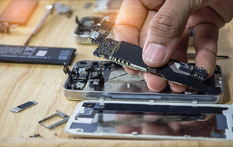 智能手机B主机架上用电话打字的母板修理工作技术工程师工具维修螺丝刀损害电子服务技术员图片