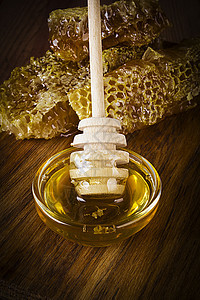 蜂蜜和蜂窝蜂蜜金子橙子勺子液体荒野蜂蜡细胞梳子营养图片