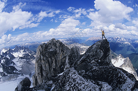 站在山顶上的人手臂攀岩者享受年轻人幸福成就身体素质胜利男士男性图片