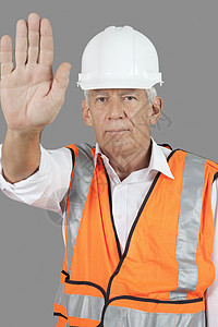 充满自信的男性建筑工人肖像与灰色背景的停止手势一触即发图片