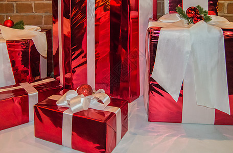 以红宝石包着的圣诞礼物盒 并绑有带装饰品的白丝带图片
