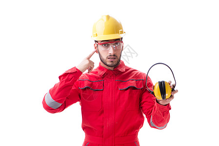 有噪音的年轻工人 取消白色耳机的声音头盔工作服安全机械修理工耳套工作领班男人工人图片