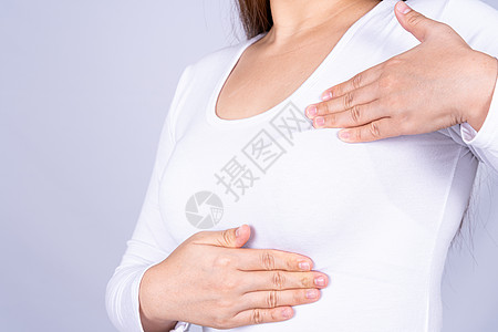 乳房肿块女性手做乳房自我检查 以检查灰色背景下的肿块和乳腺癌迹象 广告概念的医疗 保健癌症考试女士危险皮肤护理药品疾病病人丝带背景