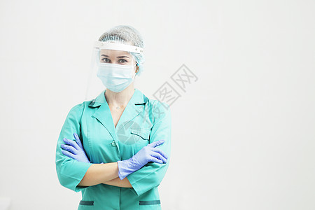 家庭医生戴防护面罩的女医生或护士 手持保护手套背景