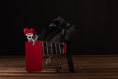 在店里用黑纸和黑色弓彩带包着的礼品盒标签折扣篮子店铺购物商业木头假期展示销售图片