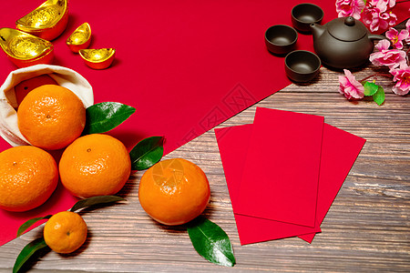 中国新年橙色 红包和中国茶叶泡信封母亲橙子财富运气月球筷子金子节日文化图片