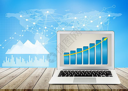 办公桌面 商业图表和图纸上的木制桌上笔记本电脑图片