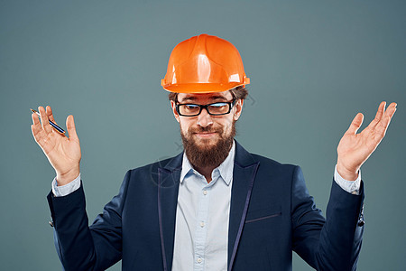 身着橙色硬帽子服装的商务人士 正式专业人员行业工人快乐蓝色工程师工作室头盔承包商成人职业安全图片