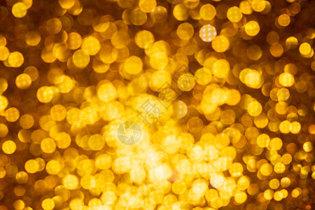 金色灯光抽象bokeh背景 基督教灯光闪耀火花彩灯庆典假期黄色圣诞色彩散景图片