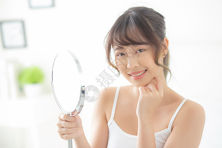 美丽美丽的年轻年轻的亚洲女人 快乐的笑容和眼神治疗护理女孩皮肤客厅镜子女士化妆品房间女性图片