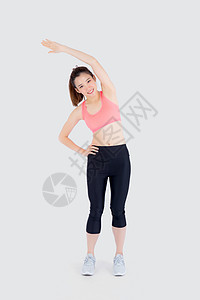运动中美丽的年轻女青年 站着伸展肌肉手臂身体健身房福利重量乐趣火车有氧运动快乐损失女孩图片