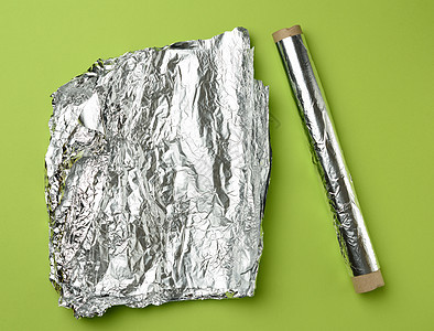 用于烘烤和在绿色背面包装食物的灰色卷纸工业床单烹饪材料边缘圆形空白反射合金金属图片