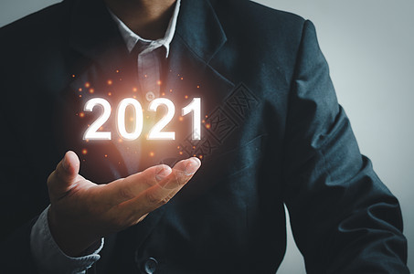 商务人士的手触摸着2021年虚拟屏幕投资项目战略日历假期成功互联网庆典营销公司图片