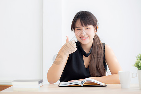 美丽的肖像 年轻的年轻亚洲女人 微笑的坐着学习女孩学生乐趣日记教育女士家庭作业商业幸福笔记图片