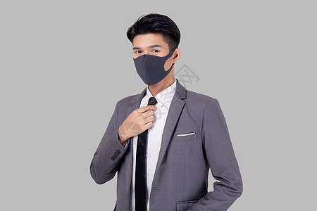 身着面罩的年轻亚洲商务人士穿着防护面具 在白色背景上与世隔绝 手握颈领带 对大流行冠状病毒进行检疫 新常态等保护性隐形生物19管图片