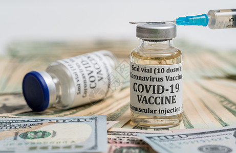 一瓶有现金的Covid19疫苗上贴紧的皮下注射器药店感染治愈贿赂投资受贿药品小瓶注射器制药图片