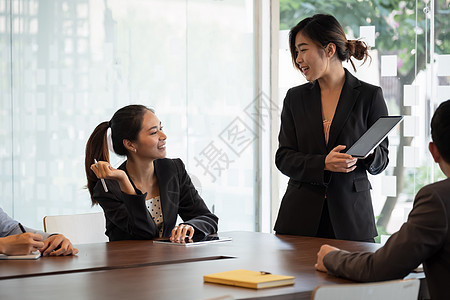 商业妇女向合作伙伴介绍新的项目  商业会议概念讨论合伙经理女士办公室男性营销团体战略工作图片