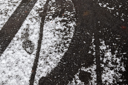 小德国 roa 上柏油路上的脏雪迹小路痕迹危险烙印城市旅行暴风雪交通车轮脚印图片