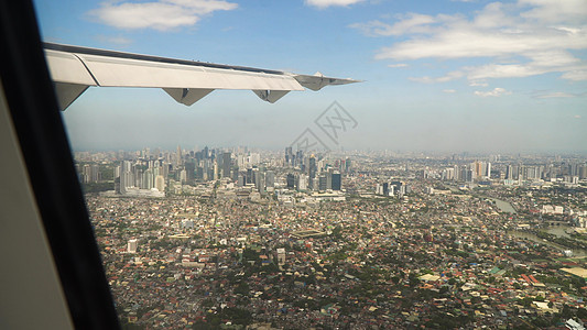 从飞机窗口看到 菲律宾的马尼拉市空气航班地平线喷射航空旅行速度客机假期航空公司图片