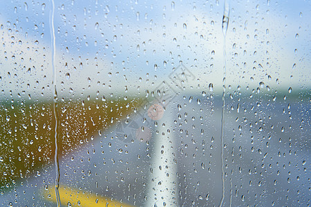 在雨天起飞前透过飞机雾蒙蒙的玻璃观看喷射航班倾盆大雨空气水滴运输航空公司技术季节天气图片