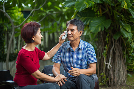 中年夫妇在后院坐在长凳上休息闲暇唱歌退休歌曲假期妻子家庭丈夫微笑幸福图片