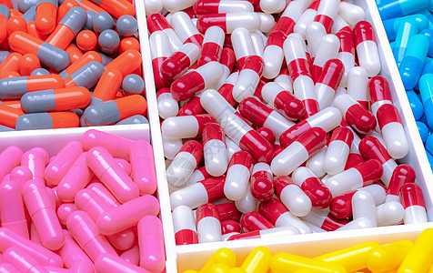 塑料托盘中的红白色 橙灰色 粉红色 蓝色和黄色胶囊 抗生素胶囊丸 医药行业 治疗感染的首选药物 抗菌药物耐药性图片