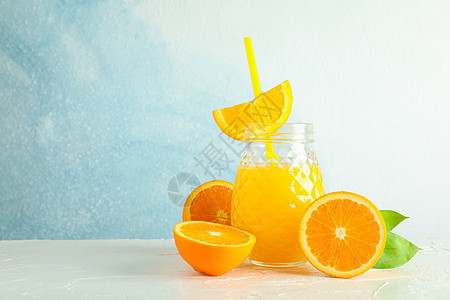 玻璃罐 有新鲜橙汁和小管 白桌上的橙子与彩色背景 文字空间 新天然饮料排毒榨汁机木头树叶早餐食物情调果汁水果桌子图片