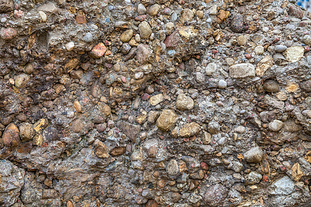 风化的石头和混凝土墙背景水泥橙子石墙墙壁斑点瓦砾石匠裂缝岩石材料图片