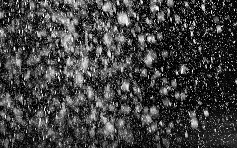 黑色背景上的水滴流动瀑布倾盆大雨淋浴运动飞溅火花倒台雨滴洪水图片