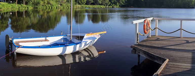 北欧一个小湖的美丽的日落风景北欧假期全景旅行海滩湖景天空池塘树木帆船蓝色图片
